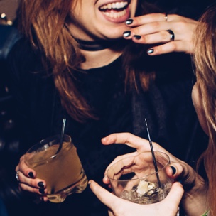 women laughing with drinks